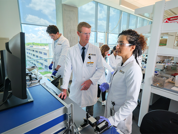 W. David Arnold (center) leads a team of researchers at the Roy Blunt NextGen Precision Health building.